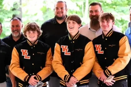 High school boys with Matt Light and their coaches